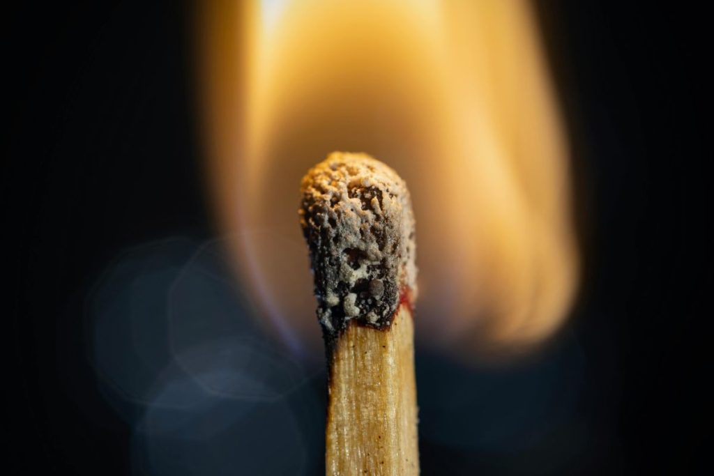 lit match on dark background